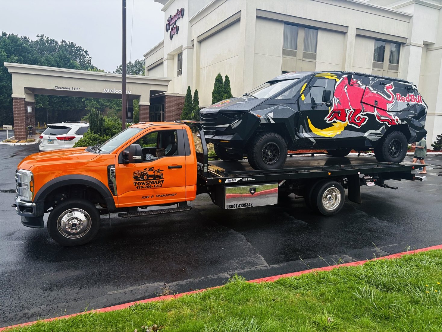 TowSmart flatbed transporting a custom Red Bull vehicle