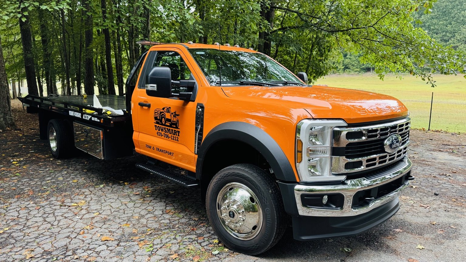 Orange TowSmart Ford flatbed truck